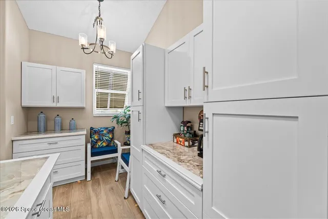 a kitchen with stainless steel appliances granite countertop white cabinets a stove a sink and dishwasher with white cabinets