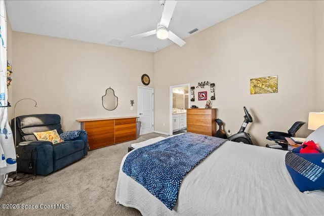 a bedroom with bed and a chandelier