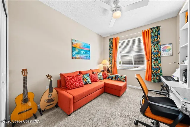 a living room with furniture a air conditioner vent and a window
