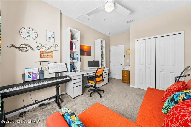 a view of a workspace with furniture and gym equipment
