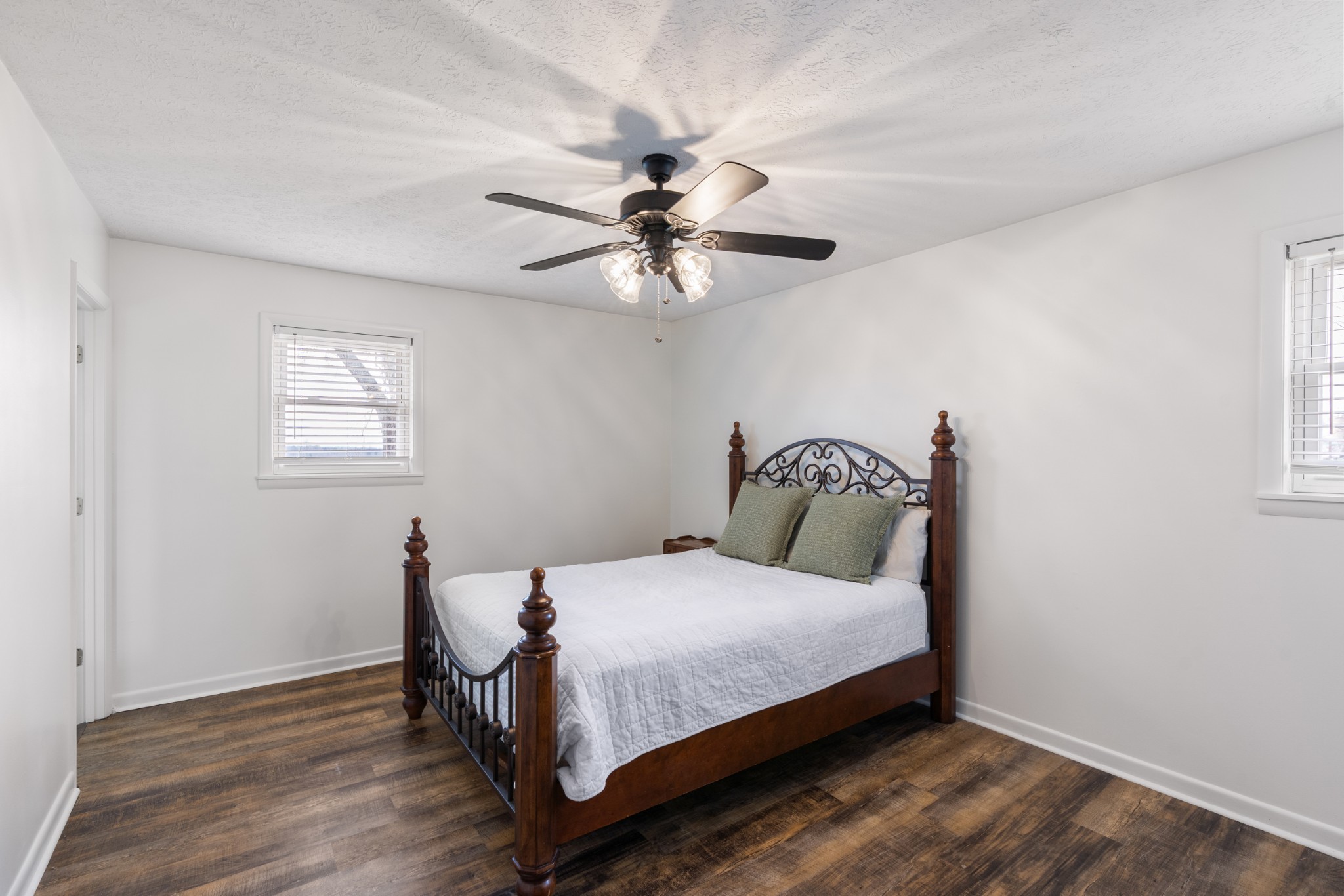 8412 Highway 41 Adams, TN 37010 - Photo 12 of 39 a bedroom with a bed and a chandelier