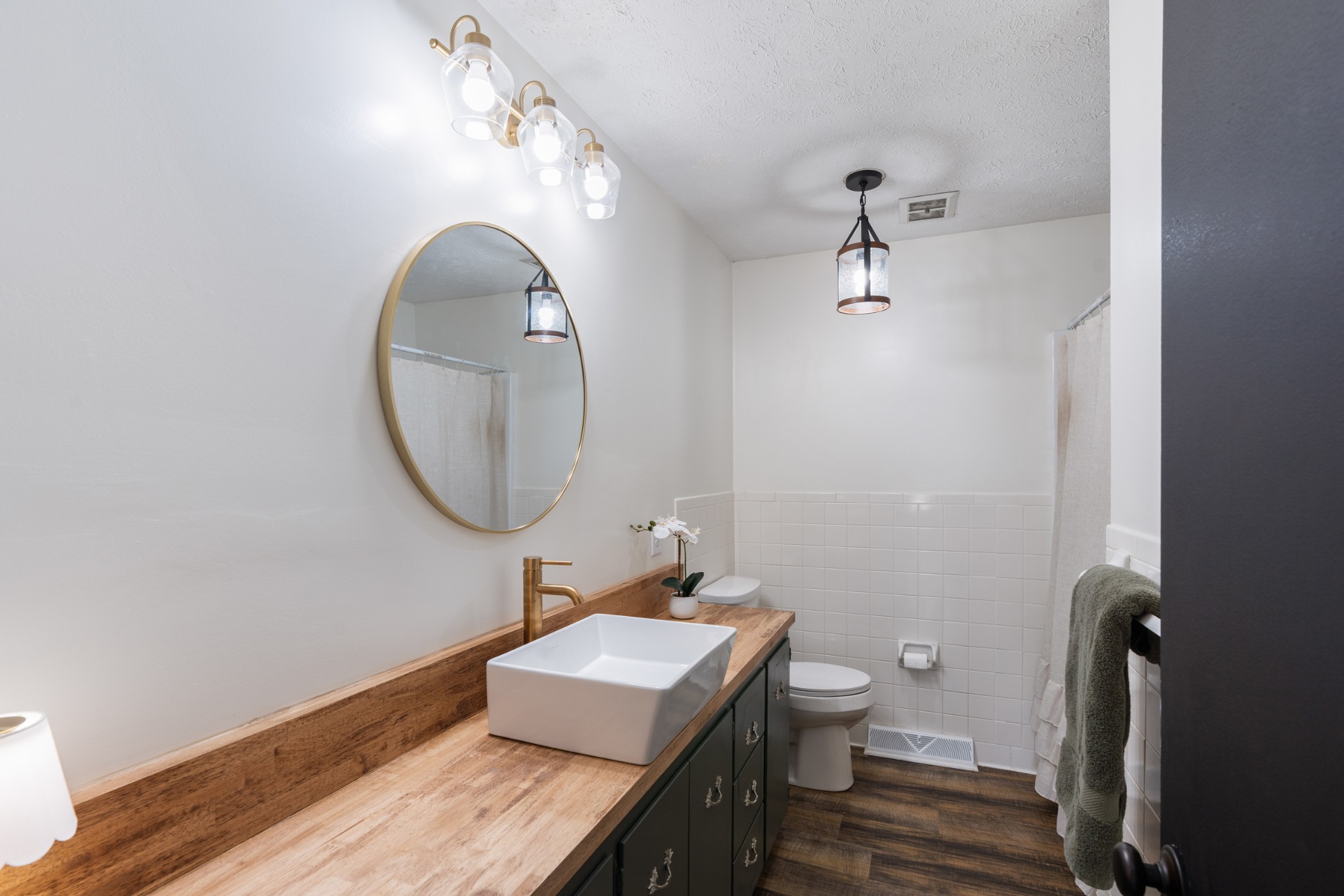 8412 Highway 41 Adams, TN 37010 - Photo 14 of 39 a bathroom with a sink a toilet and a mirror
