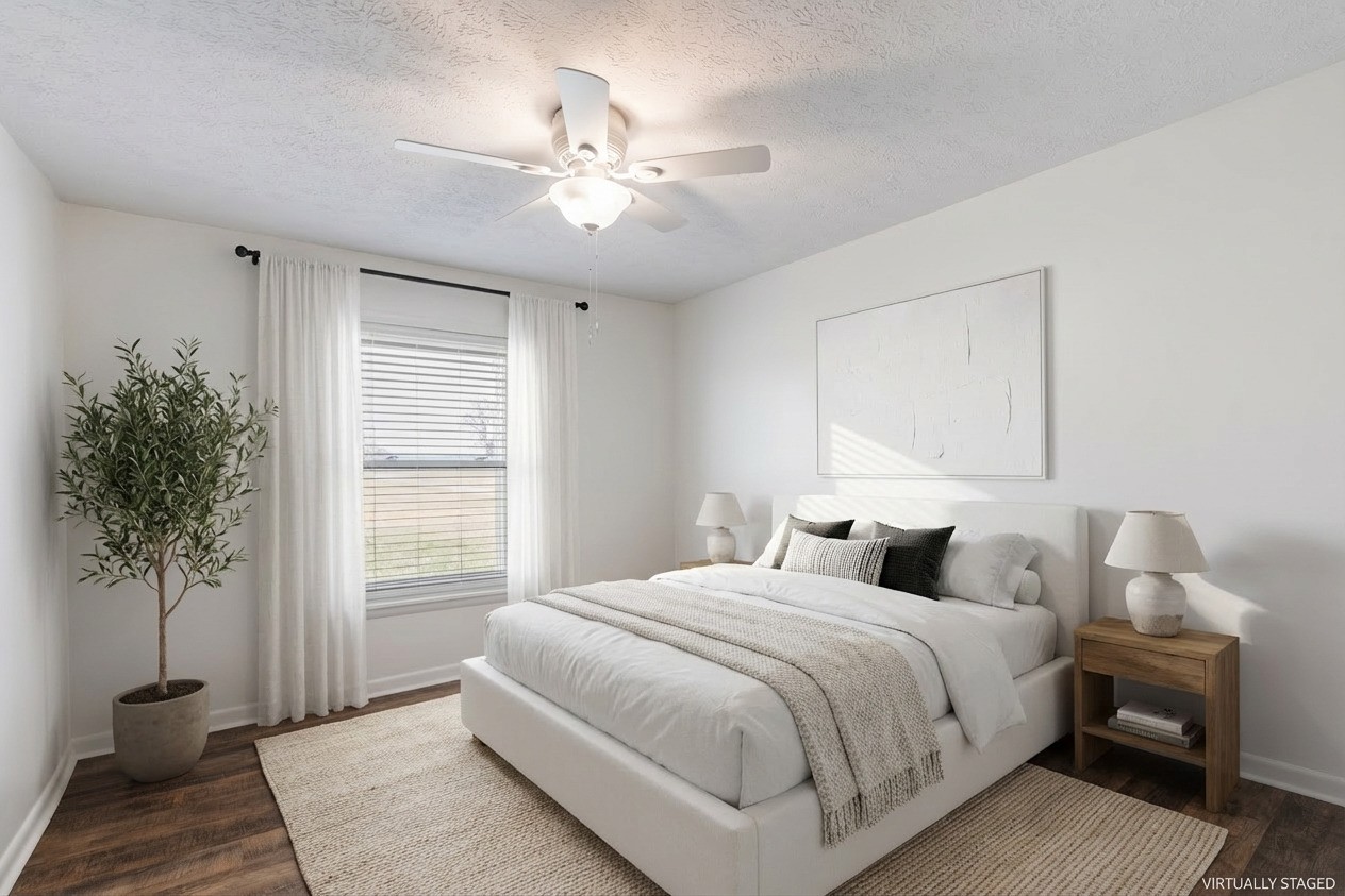 8412 Highway 41 Adams, TN 37010 - Photo 15 of 39 a bedroom with a large bed and a chandelier