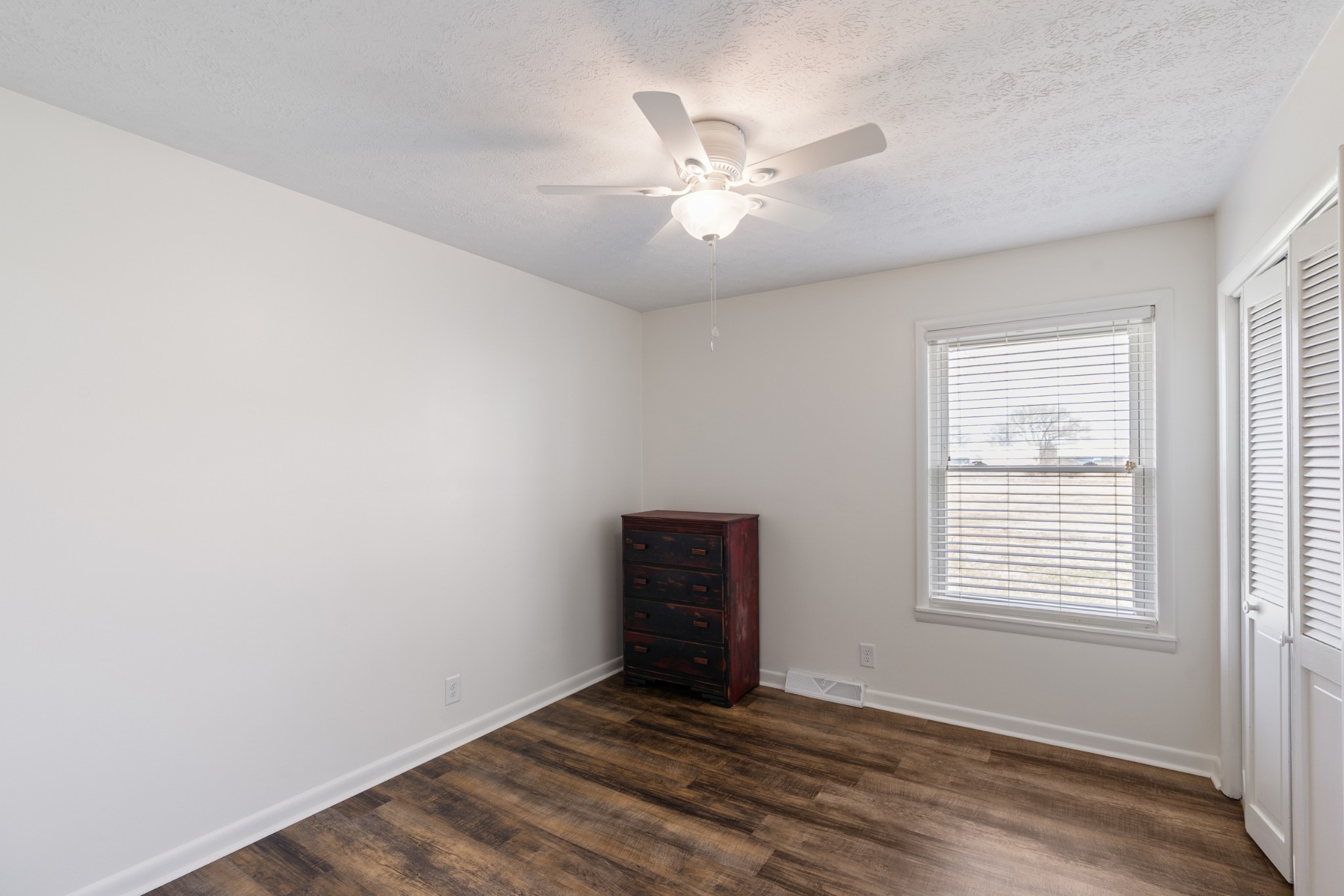 8412 Highway 41 Adams, TN 37010 - Photo 18 of 39 a view of an empty room with wooden floor and a window