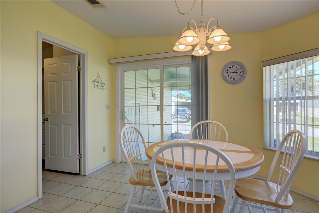 823 Tamarind Circle Sebastian, FL 32976 - Photo 13 of 33 a view of a dining room with furniture and a chandelier