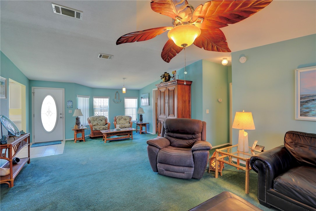 823 Tamarind Circle Sebastian, FL 32976 - Photo 6 of 33 a living room with furniture a chandelier fan and a window