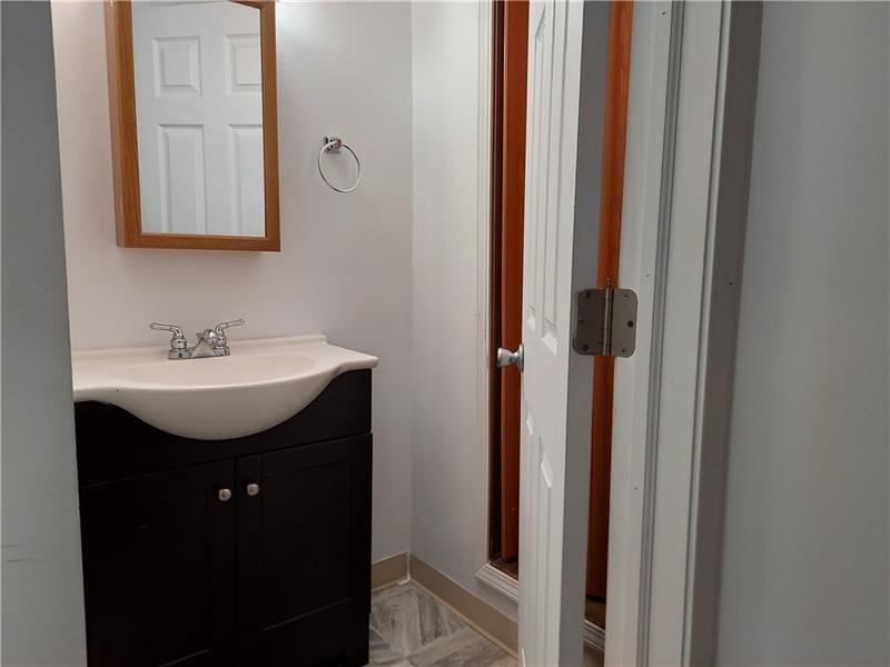5801 Lincoln Avenue, Unit B Export, PA 15632 - Photo 13 of 19 a bathroom with a sink a mirror a vanity and shower