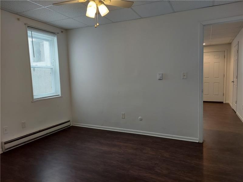 5801 Lincoln Avenue, Unit B Export, PA 15632 - Photo 14 of 19 an empty room with wooden floor and windows