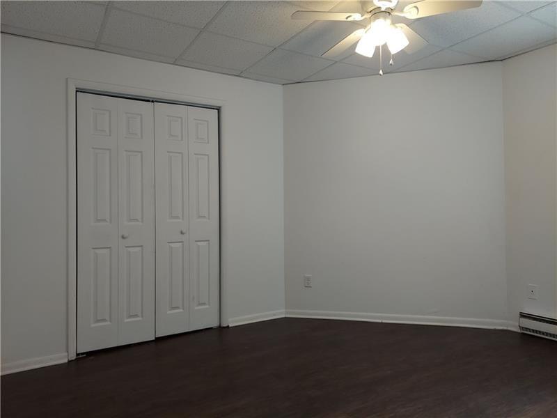 5801 Lincoln Avenue, Unit B Export, PA 15632 - Photo 8 of 19 an empty room with wooden floor and closet area