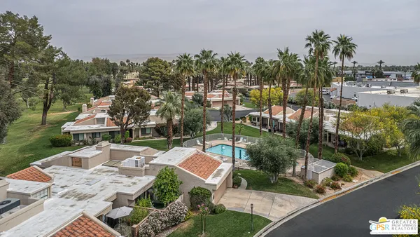 a view of a swimming pool and outdoor seating