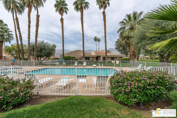 a view of a swimming pool with a patio and a garden