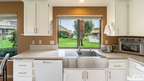 a kitchen with stainless steel appliances granite countertop a sink and cabinets