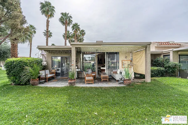 a view of a house with backyard porch and sitting area