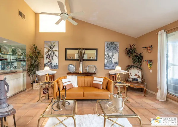 a living room with furniture and a floor to ceiling window