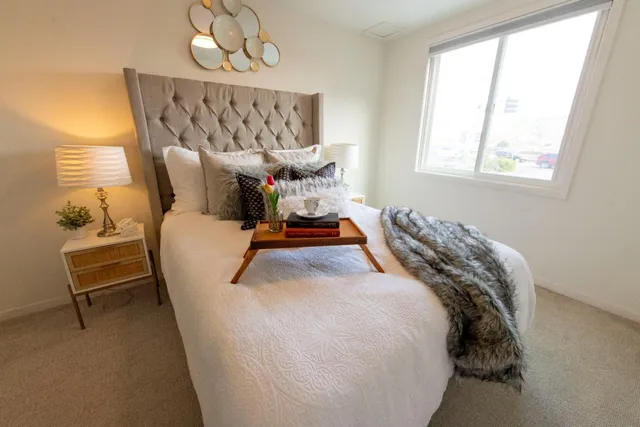 a bed sitting in a bedroom next to a window