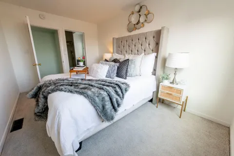 a bedroom with bed and a window