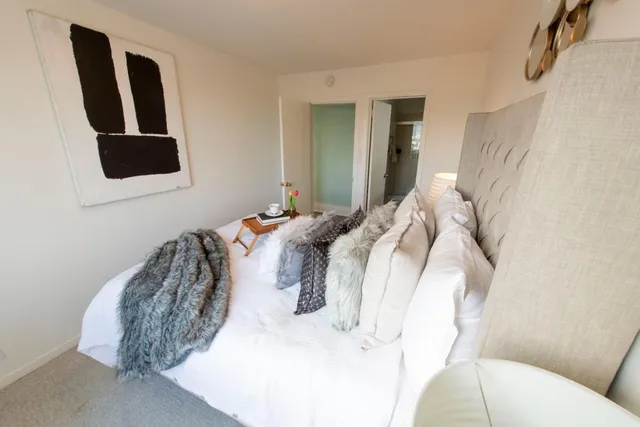 a bedroom with a bed and a mirror