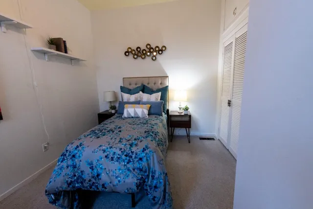 a bedroom with a bed and a window