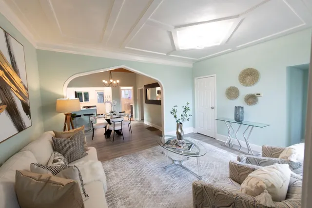 a living room with furniture and a chandelier