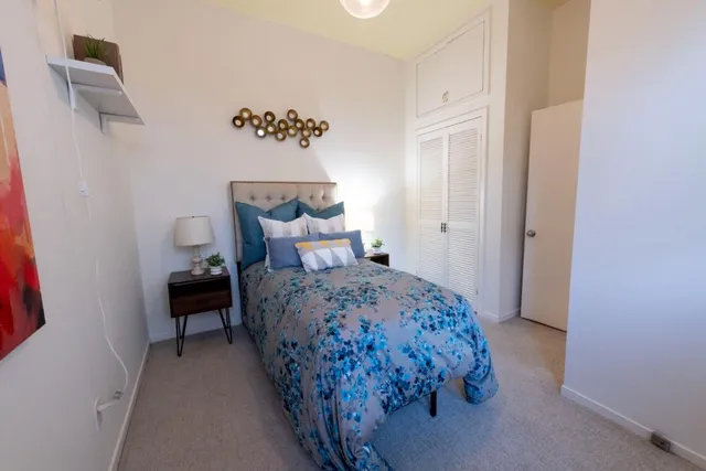 a bedroom with a bed and a lamp