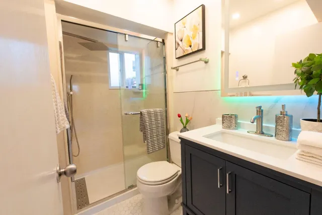 a bathroom with a sink toilet and shower