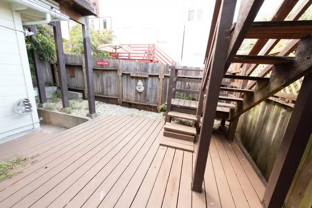 a view of balcony with wooden floor and outdoor seating