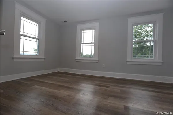 a view of entryway and hall with wooden floor