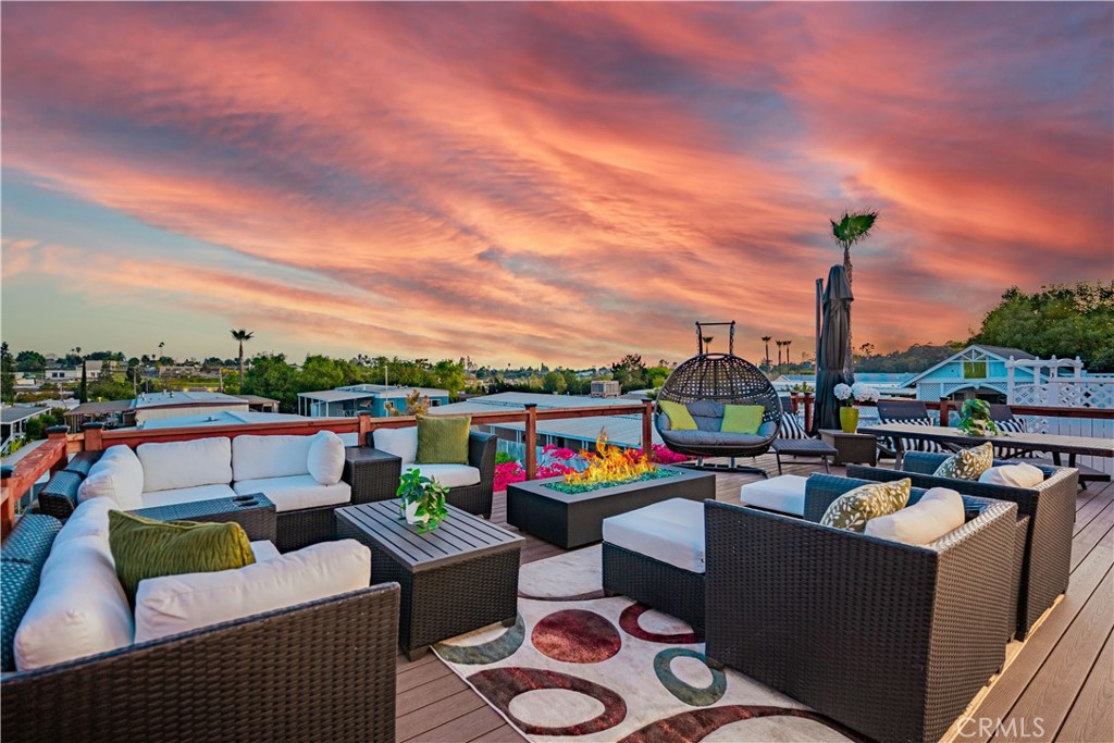 a view of a roof deck with couches and potted plants