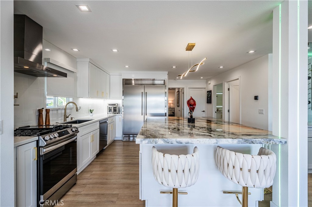 1120 East Mission Road, Unit 102 Fallbrook, CA 92028 - Photo 19 of 62 a kitchen with stainless steel appliances granite countertop a sink a stove and a refrigerator