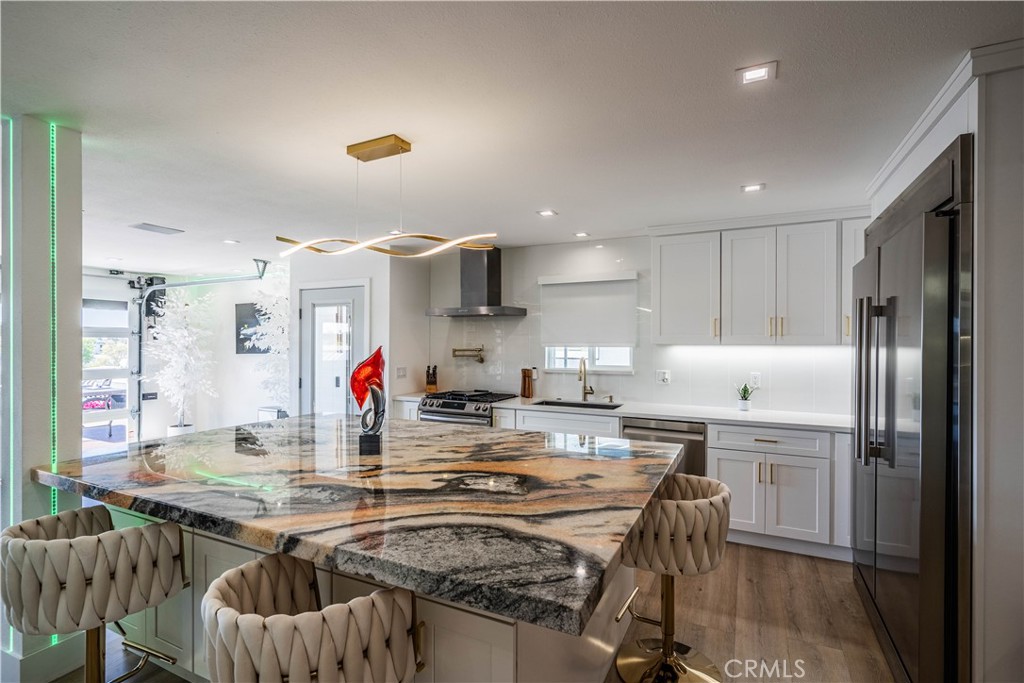 1120 East Mission Road, Unit 102 Fallbrook, CA 92028 - Photo 22 of 62 a kitchen with kitchen island a table and chairs