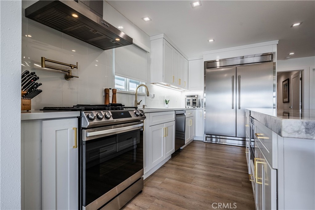 1120 East Mission Road, Unit 102 Fallbrook, CA 92028 - Photo 23 of 62 a kitchen with granite countertop a stove and a refrigerator