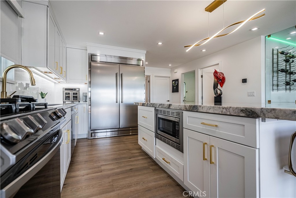 1120 East Mission Road, Unit 102 Fallbrook, CA 92028 - Photo 24 of 62 a kitchen with stainless steel appliances granite countertop a stove and a refrigerator