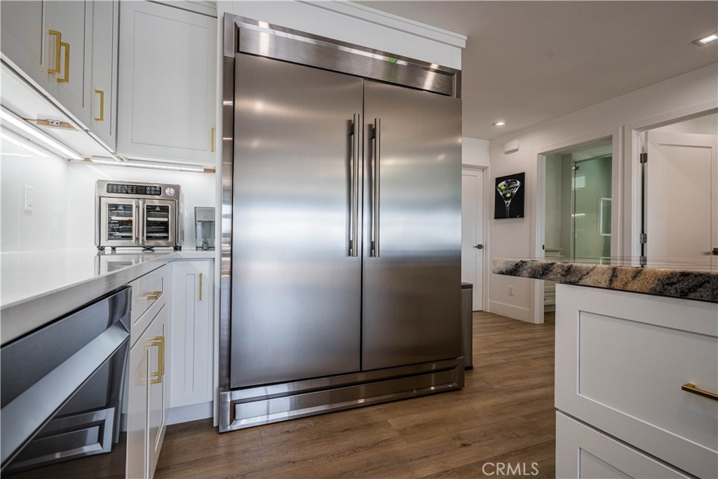 1120 East Mission Road, Unit 102 Fallbrook, CA 92028 - Photo 25 of 62 a kitchen with kitchen island a counter top space and stainless steel appliances