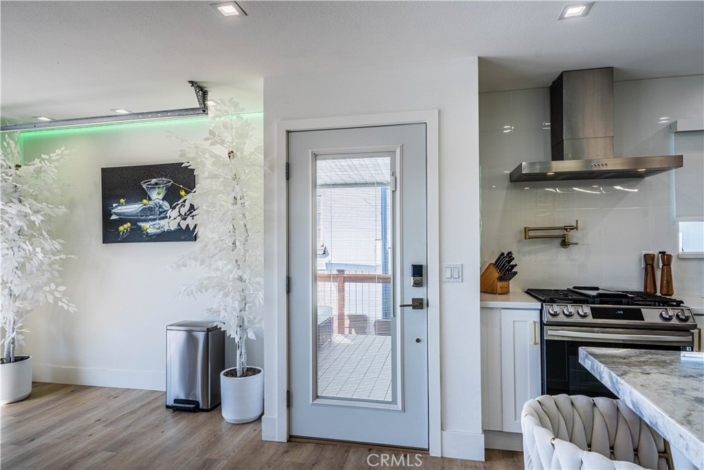 1120 East Mission Road, Unit 102 Fallbrook, CA 92028 - Photo 26 of 62 a kitchen with stainless steel appliances granite countertop a refrigerator and a stove