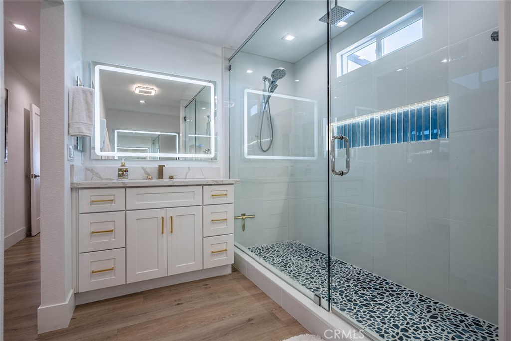 1120 East Mission Road, Unit 102 Fallbrook, CA 92028 - Photo 29 of 62 a bathroom with a double vanity sink a mirror and shower