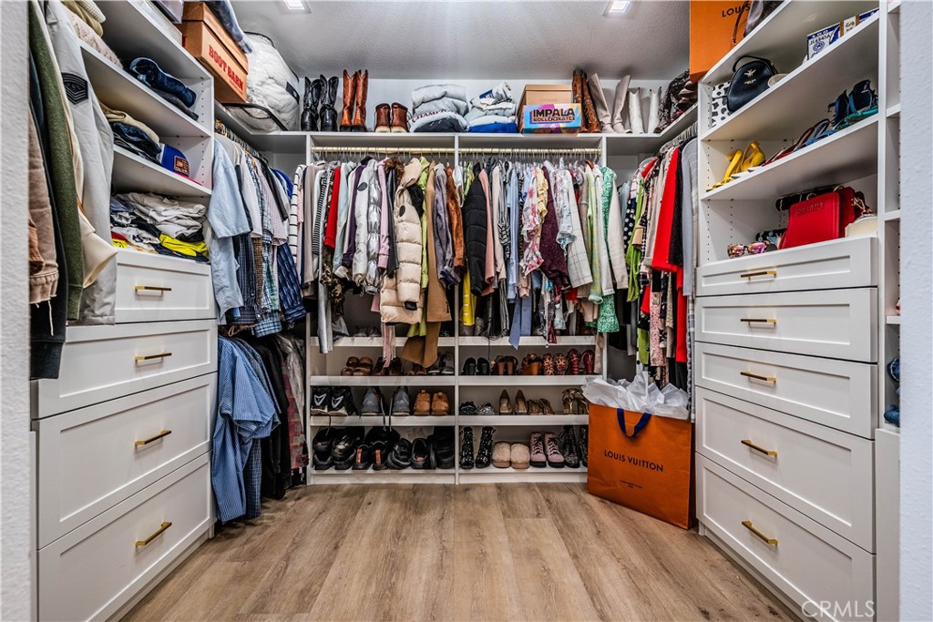 1120 East Mission Road, Unit 102 Fallbrook, CA 92028 - Photo 31 of 62 a view of walk in closet with clothes and shoes