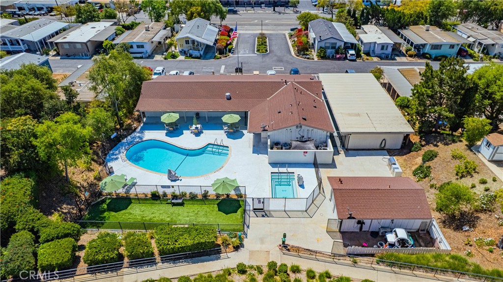 1120 East Mission Road, Unit 102 Fallbrook, CA 92028 - Photo 50 of 62 an aerial view of residential houses with outdoor space and parking