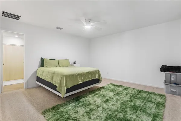 a bedroom with a bed and chair