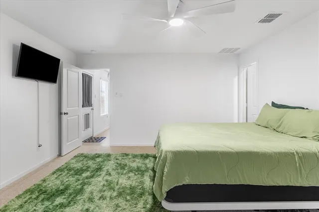 a bedroom with a bed and flat screen tv