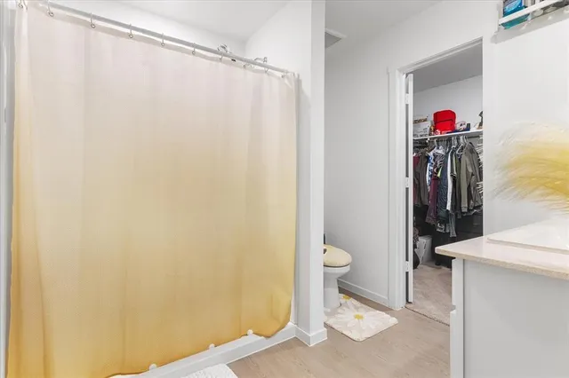a bathroom with a toilet and a shower curtain