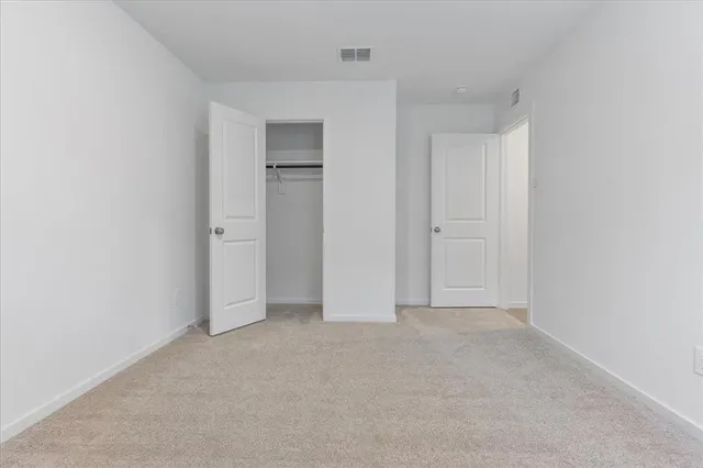 a view of an empty room and closet area