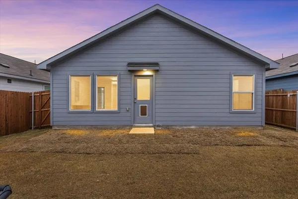 a view of a house with a fence