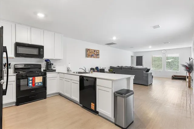 a kitchen with sink cabinets and stainless steel appliances