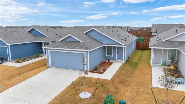a view of a house with a backyard