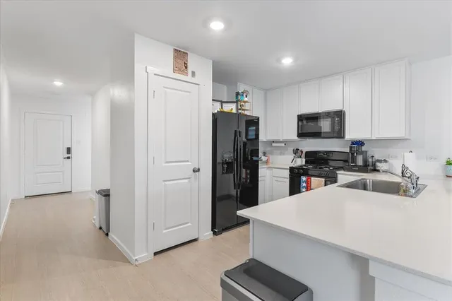 a kitchen with stainless steel appliances a refrigerator and a stove top oven