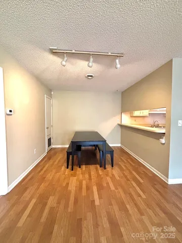 a view of an empty room with a fireplace and a window