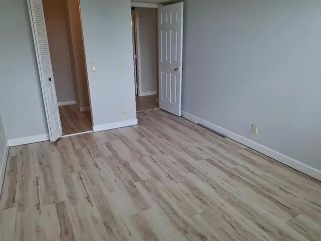 an empty room with wooden floor