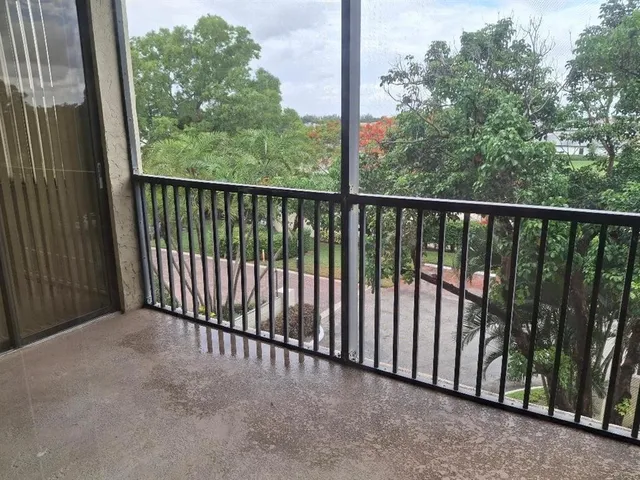 a view of a balcony with yard