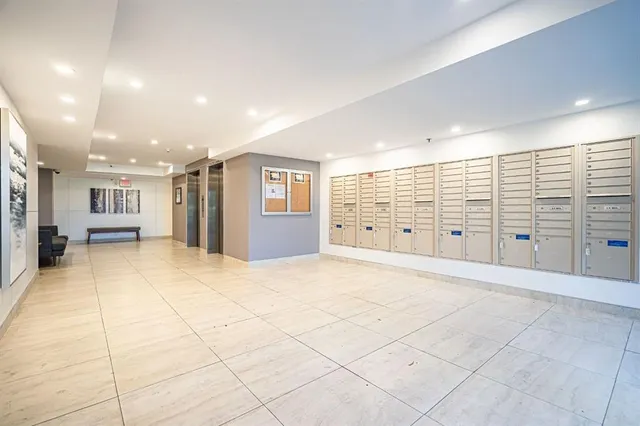 a living room with furniture and a painting on the wall