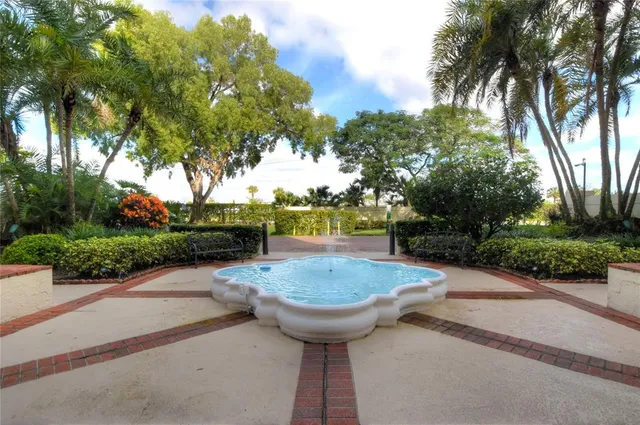 a front view of a house with a yard and a garden